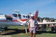 John in front of airplane, Wanigela
